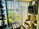 A sunroom with serene lake views, featuring comfortable seating and decor at 4072 Oakview Dr # C5, Punta Gorda, FL 33980