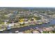 Aerial view of neighborhood showcasing home's waterfront location along a canal with access to a larger body of water at 4091 Rock Creek Dr, Port Charlotte, FL 33948
