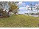 Enjoy this spacious backyard overlooking the canal and featuring mature trees and a well-maintained lawn at 4091 Rock Creek Dr, Port Charlotte, FL 33948