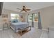 Comfortable bedroom with neutral walls, a ceiling fan, two windows and a soft blue bedspread at 4091 Rock Creek Dr, Port Charlotte, FL 33948