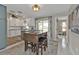 Open dining area with wood table, bar stools, and sliding doors to the backyard at 4091 Rock Creek Dr, Port Charlotte, FL 33948