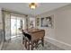 Cozy dining area with access to the backyard patio and a sunlit bedroom at 4091 Rock Creek Dr, Port Charlotte, FL 33948