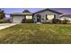 Charming home with a manicured lawn, blue shutters, and a well-lit entrance, offering great curb appeal at 4091 Rock Creek Dr, Port Charlotte, FL 33948