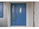 Close up of the home's blue front door with decorative glass and sidelight at 4091 Rock Creek Dr, Port Charlotte, FL 33948