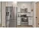 Functional kitchen featuring stainless steel appliances, white cabinets, and modern countertops, maximizing cooking efficiency at 4091 Rock Creek Dr, Port Charlotte, FL 33948