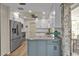 Well-equipped kitchen with stainless steel appliances, white cabinets, and a central island, blending style and functionality at 4091 Rock Creek Dr, Port Charlotte, FL 33948