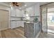 Modern kitchen featuring white cabinets, stainless steel appliances, and granite countertops, offering a sleek aesthetic at 4091 Rock Creek Dr, Port Charlotte, FL 33948