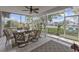 The screened lanai offers outdoor seating with views of the canal and nearby landscaping at 4091 Rock Creek Dr, Port Charlotte, FL 33948