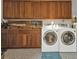 This organized laundry room features front-loading machines, ample cabinets, and plenty of counter space at 4091 Rock Creek Dr, Port Charlotte, FL 33948