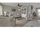 Cozy living room featuring a stylish sofa, comfortable armchairs, and a built-in bookcase display at 4091 Rock Creek Dr, Port Charlotte, FL 33948