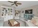 Open living room with tile flooring, a decorative cabinet, and a large television for comfortable gatherings at 4091 Rock Creek Dr, Port Charlotte, FL 33948