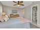 Comfortable bedroom featuring a ceiling fan, dresser and closet at 4091 Rock Creek Dr, Port Charlotte, FL 33948