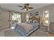 Comfortable main bedroom with sliding door access to patio and a ceiling fan at 4091 Rock Creek Dr, Port Charlotte, FL 33948