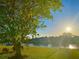 Scenic waterfront view featuring lush greenery and a dock, perfect for boating and enjoying nature at 4091 Rock Creek Dr, Port Charlotte, FL 33948