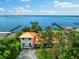 Waterfront home featuring a private dock, lush landscaping, and stunning bay views from above at 4498 Northshore Dr, Punta Gorda, FL 33980