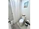 Cozy bathroom featuring a toilet with decor and a shower with a curtain at 503 Atwater St, Port Charlotte, FL 33954