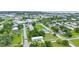 Neighborhood aerial showing a charming single-story home with a metal roof, fresh green paint, and landscaping at 535 Milus St, Punta Gorda, FL 33950