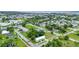 Neighborhood aerial showing a charming single-story home with a metal roof, fresh green paint, and landscaping at 535 Milus St, Punta Gorda, FL 33950