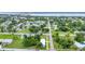 Wide neighborhood aerial showing a charming single-story home with a metal roof, fresh green paint, and landscaping at 535 Milus St, Punta Gorda, FL 33950