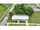 View of a charming single-story home with a metal roof, fresh green paint, and lush landscaping at 535 Milus St, Punta Gorda, FL 33950