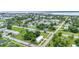 Wide neighborhood aerial showing a charming single-story home with a metal roof, fresh green paint, and landscaping at 535 Milus St, Punta Gorda, FL 33950