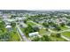 Neighborhood aerial showing a charming single-story home with a metal roof, fresh green paint, and landscaping at 535 Milus St, Punta Gorda, FL 33950