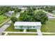 A charming single-story home with a metal roof, fresh green paint, and lush landscaping at 535 Milus St, Punta Gorda, FL 33950