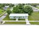 A charming single-story home with a metal roof, fresh green paint, and lush landscaping at 535 Milus St, Punta Gorda, FL 33950