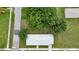 High angle view of a home with a metal roof, fresh green paint, and landscaping at 535 Milus St, Punta Gorda, FL 33950