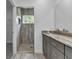 Bathroom showcasing a walk-in shower with stylish tilework and a double vanity at 535 Milus St, Punta Gorda, FL 33950