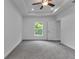 Spacious bedroom featuring a tray ceiling, ceiling fan, and a window view at 535 Milus St, Punta Gorda, FL 33950