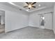 Primary bedroom featuring a ceiling fan and a barn door leading into an ensuite at 535 Milus St, Punta Gorda, FL 33950