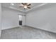 Primary bedroom featuring a ceiling fan and a barn door leading into an ensuite at 535 Milus St, Punta Gorda, FL 33950