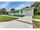Exterior of mint home with an attached garage and a long driveway at 535 Milus St, Punta Gorda, FL 33950