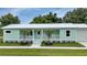 Inviting home exterior features a covered front porch at 535 Milus St, Punta Gorda, FL 33950