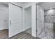 Hallway featuring barn door and doorway views into bathroom and closet spaces at 535 Milus St, Punta Gorda, FL 33950