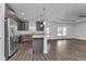 Modern kitchen featuring stainless steel appliances, stone countertops, and hardwood floors at 535 Milus St, Punta Gorda, FL 33950