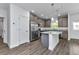 Beautiful kitchen featuring stainless appliances, gray cabinets and a center island at 535 Milus St, Punta Gorda, FL 33950