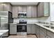 Modern kitchen featuring stainless steel appliances and stone countertops at 535 Milus St, Punta Gorda, FL 33950