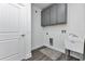 Well-lit laundry area with upper cabinets, utility sink and washer/dryer hookups at 535 Milus St, Punta Gorda, FL 33950