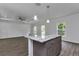 Open-concept living room with hardwood floors and a center island kitchen at 535 Milus St, Punta Gorda, FL 33950