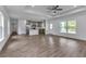 Open-concept living room with hardwood floors and a center island kitchen at 535 Milus St, Punta Gorda, FL 33950