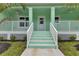 Inviting front porch featuring a white railing and stairs at 535 Milus St, Punta Gorda, FL 33950