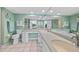 Spacious bathroom featuring dual sinks, a large mirror, and white tile flooring at 601 Shreve St # 62A, Punta Gorda, FL 33950