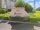 Welcoming Banyan Point entrance sign with lush landscaping and a bright, sunny sky overhead at 601 Shreve St # 62A, Punta Gorda, FL 33950