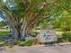 The Banyan Point exit sign is framed by a mature banyan tree adding a natural and serene touch at 601 Shreve St # 62A, Punta Gorda, FL 33950