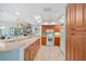 Bright kitchen features wooden cabinets, white appliances, and a breakfast bar at 601 Shreve St # 62A, Punta Gorda, FL 33950