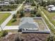 Aerial view of fenced property with landscaping, home and adjacent canal at 7095 Beardsley St, Englewood, FL 34224