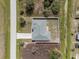 Aerial view of fenced property, landscaping, and proximity to adjacent street at 7095 Beardsley St, Englewood, FL 34224