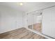 Bedroom featuring wood-look floors and closet with mirrored sliding doors at 7095 Beardsley St, Englewood, FL 34224